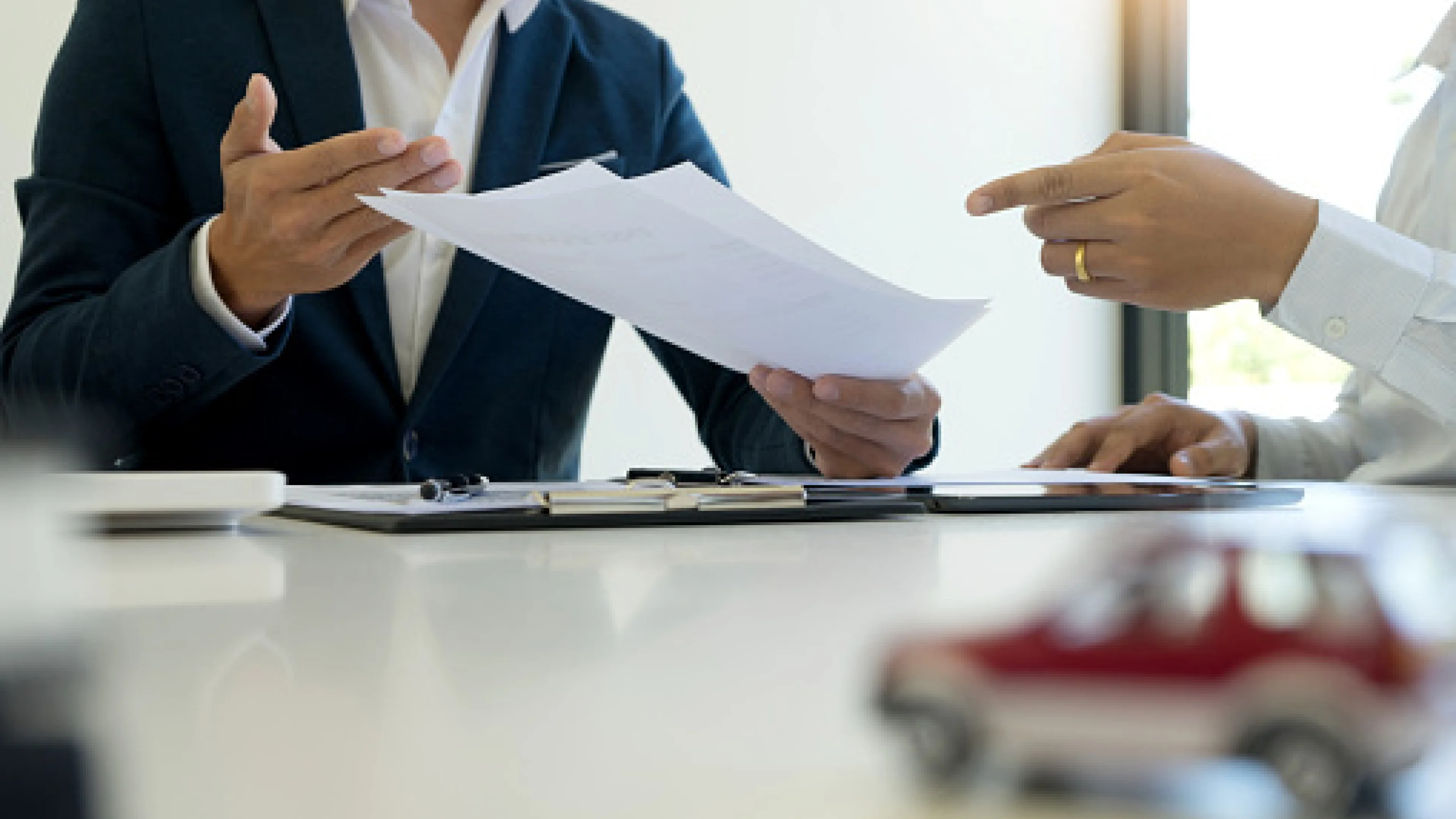 People handing over documents in a meeting