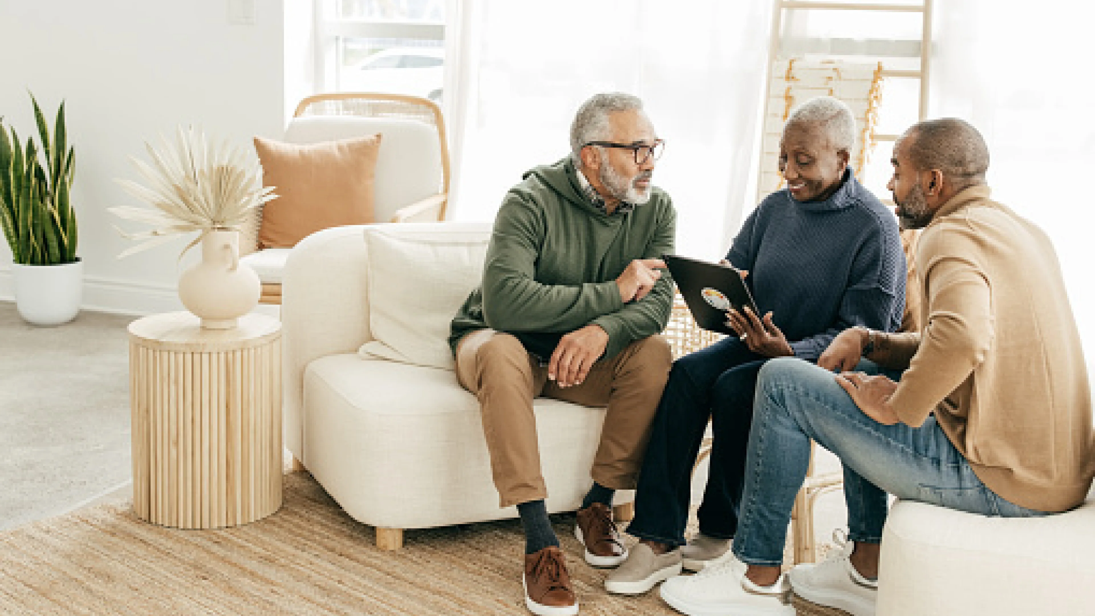 Group of diverse people going over something on a tablet